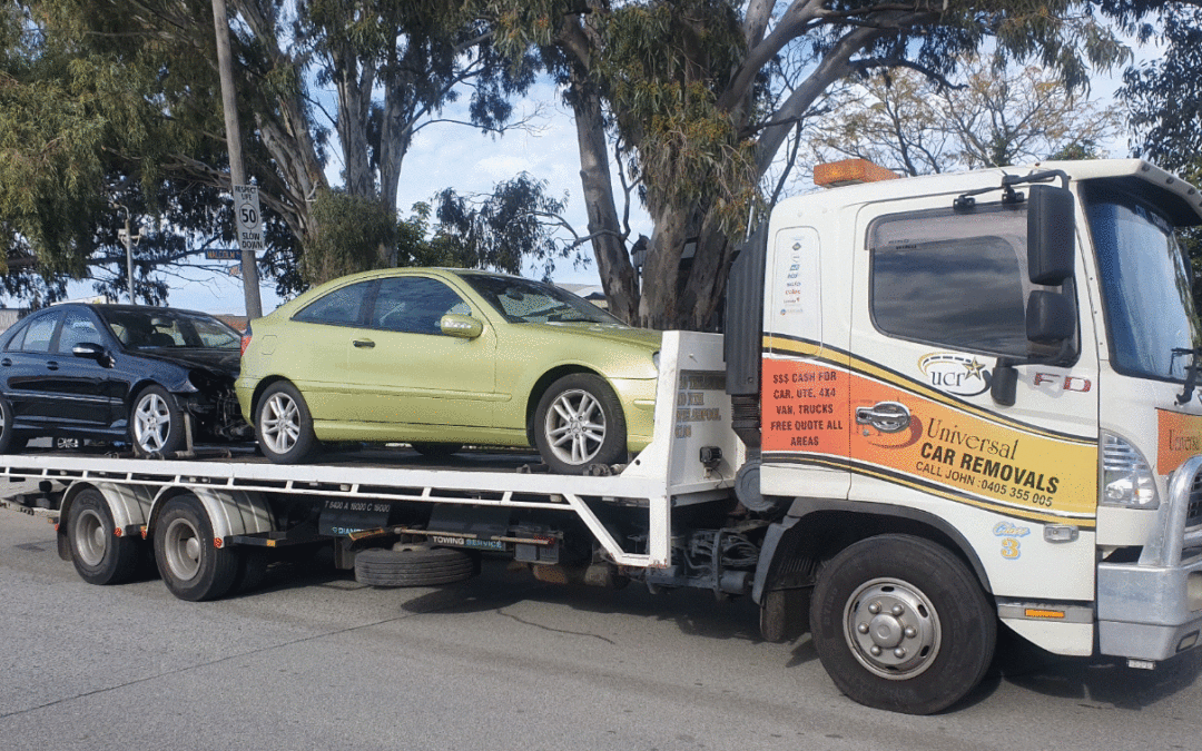 Tow truck with two cars going to Perth