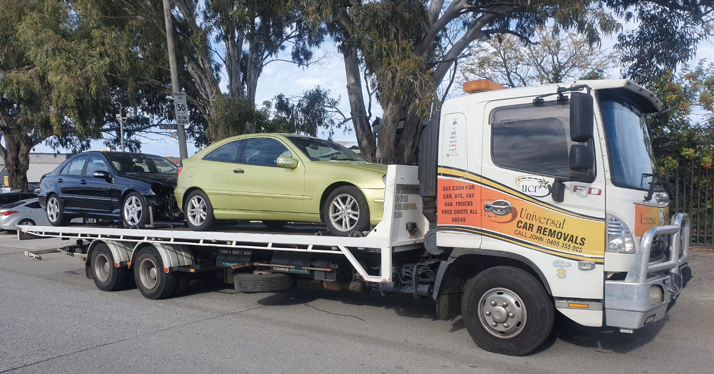 Tow truck with two cars going to Perth